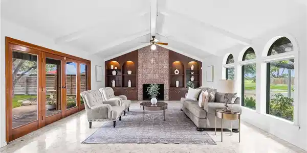 Image 3: Gather around the fireplace in this inviting main