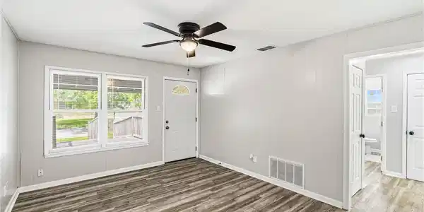 Image 3: Freshly painted living room with updated vinyl pla