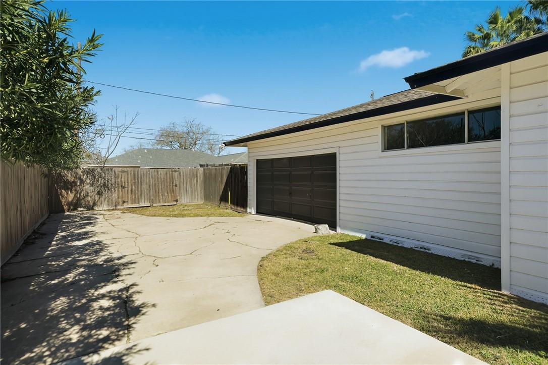 Image 3: View of the garage and extended driveway.