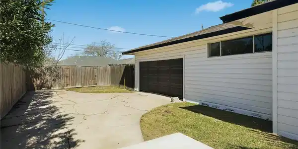 Image 3: View of the garage and extended driveway.