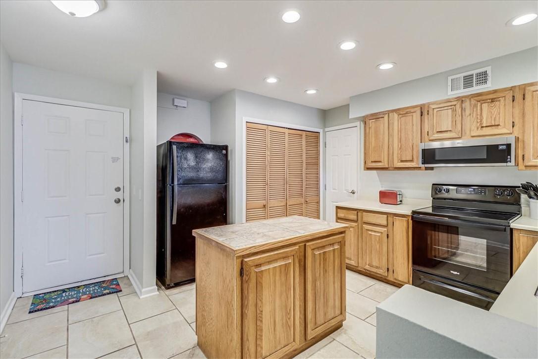 Image 4: Kitchen with island and laundry closet.
