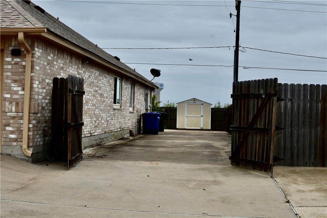 Image 4: Right side of home.  Gate is 11' wide.  Parking is