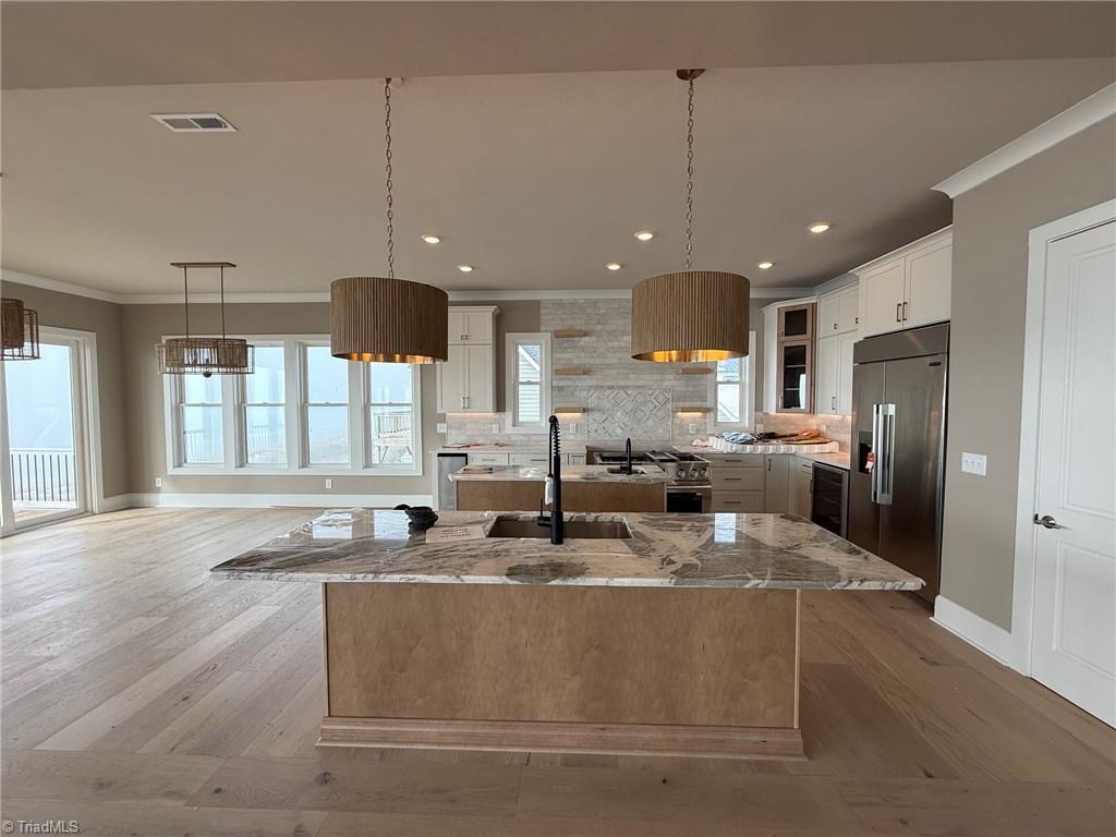 Image 2: Main Living Level Kitchen Has Food Prep Island And Serving/Seating Island