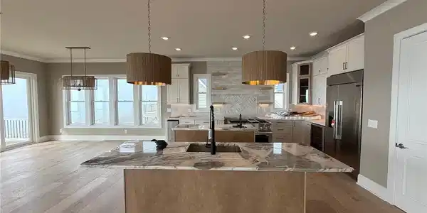 Image 2: Main Living Level Kitchen Has Food Prep Island And Serving/Seating Island